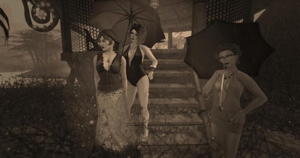 sepia toned photo of RMarie Beedit, Vanessa Blaylock and Soto Hax standing in the rain in a jungle brush area