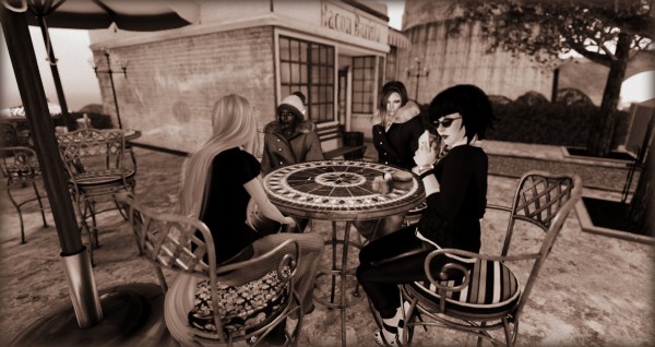 4 avatars sit at a terrace table outside Bacon Barista