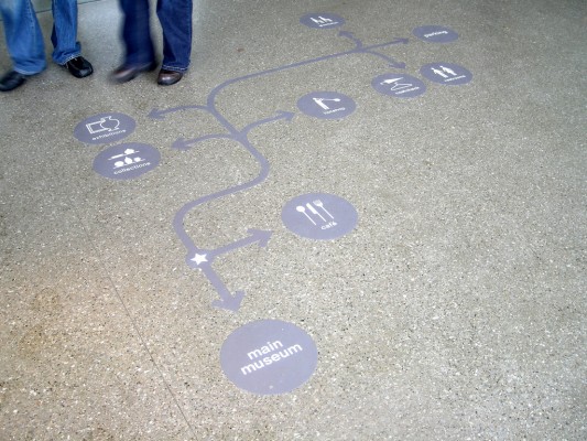 University Guiding Principles: photo of a wayfinding aid / map embedded in the walking spaces of an institution