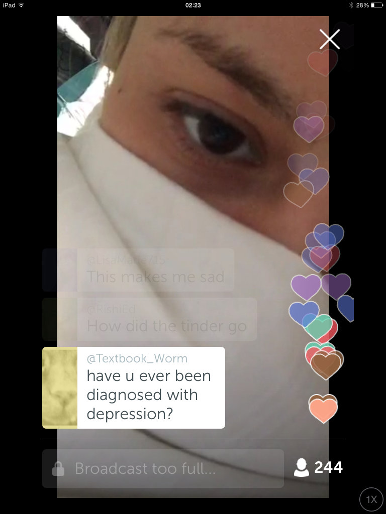 Screen Cap of Bree Olson on Periscope. Olson is in bed with a sheet around her mouth and nose and only one eye poking through to the camera in an extreme closeup. Her image is superimposed by Periscope "hearts" trickling up the screen and with a comment from @Textbook_Worm, "Have you ever been diagnosed with depression?"
