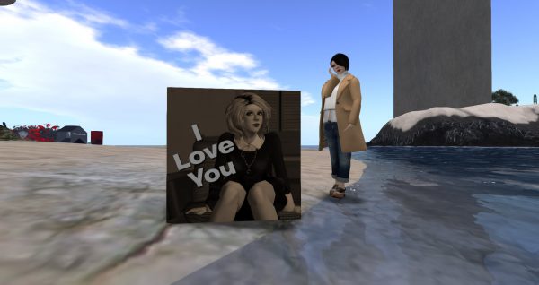 Vanessa Blaylock standing next to a cube bearing her photo and the words "I Love You"