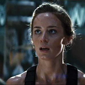 still image from the film Edge of Tomorrow showing Emily Blunt in a purple tank top and covered in sweat